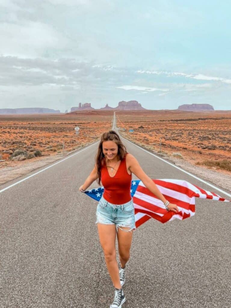 we-woman-american-flag-desert-highway